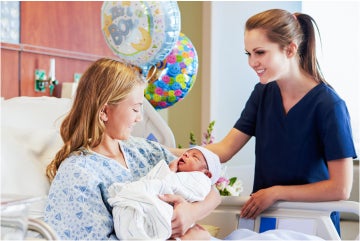 Female nurse with mother and newborn