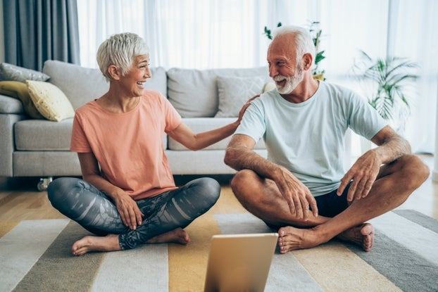 An older couple practicing meditative yoga