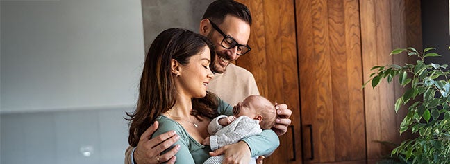 Happy family holding newborn baby